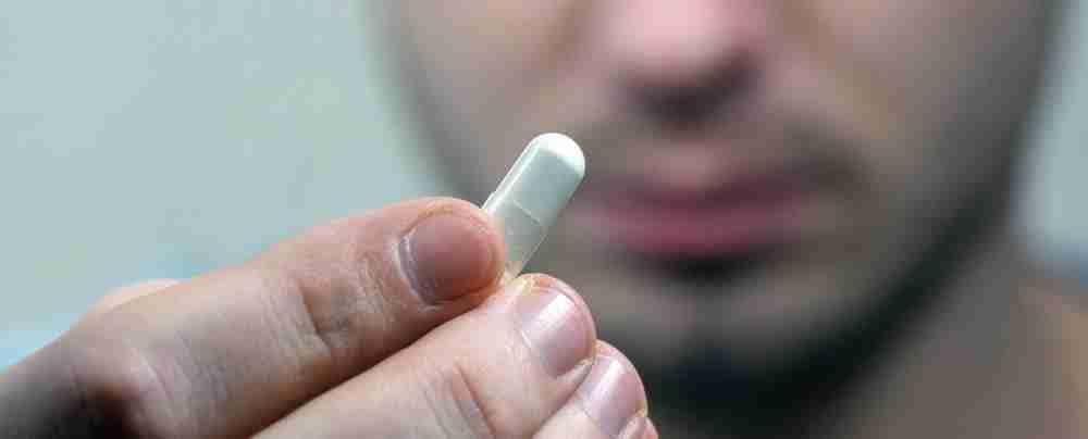 man taking a pill