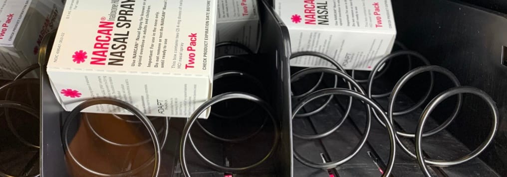 Boxes of Narcan in a dispenser