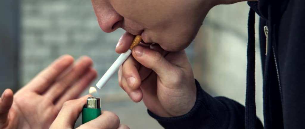 Young person smoking a cigarette