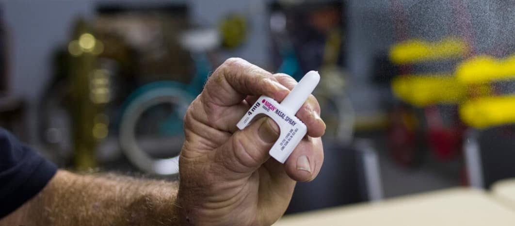 hand holding Narcan