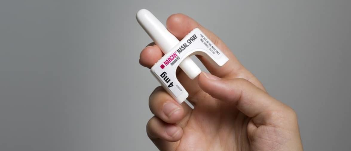 hand holding Naloxone inhaler