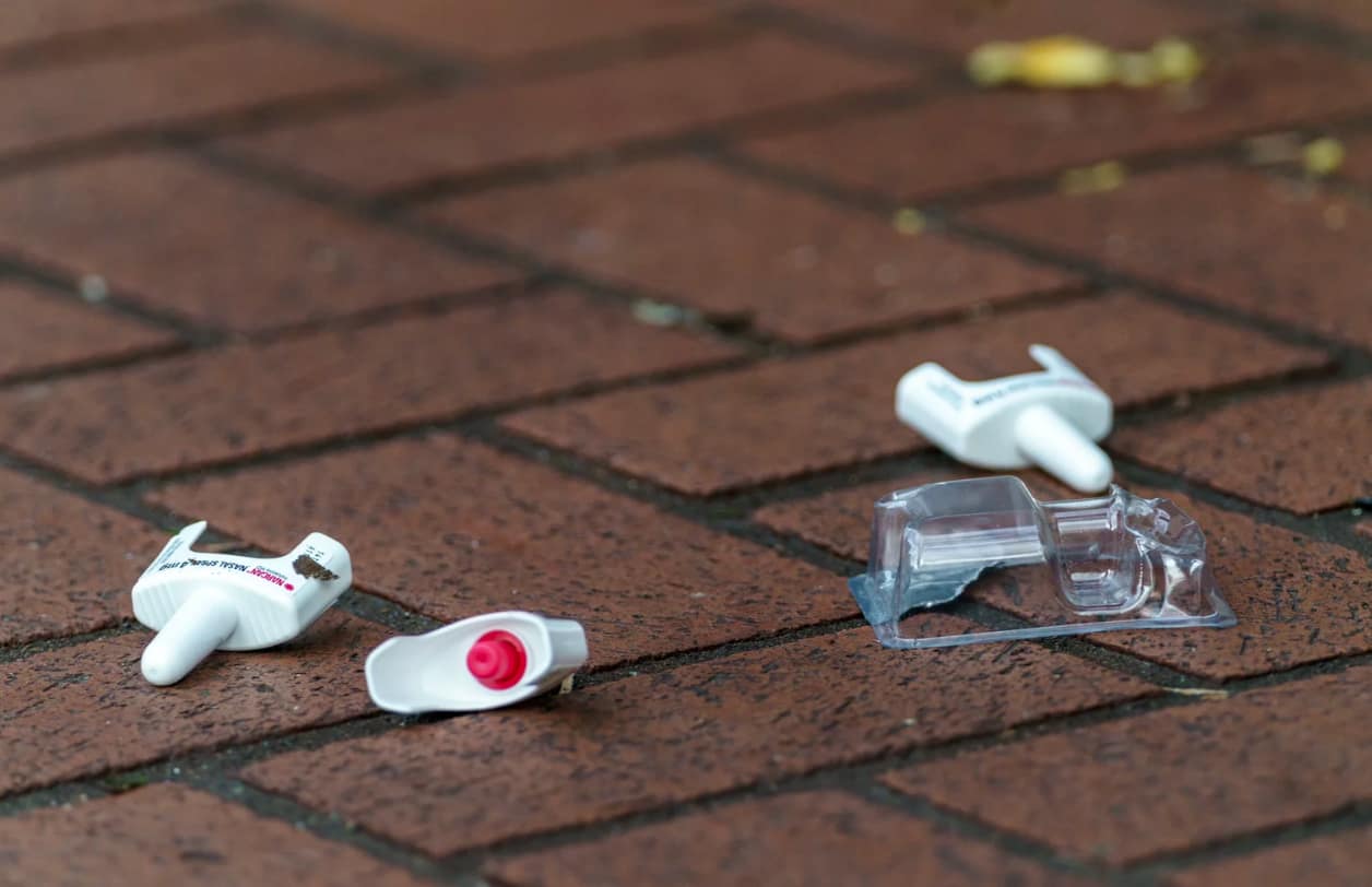 used Narcan applicators on the ground