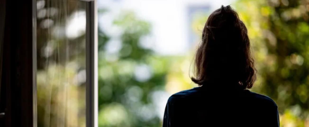 view of girl from behind, looking out window