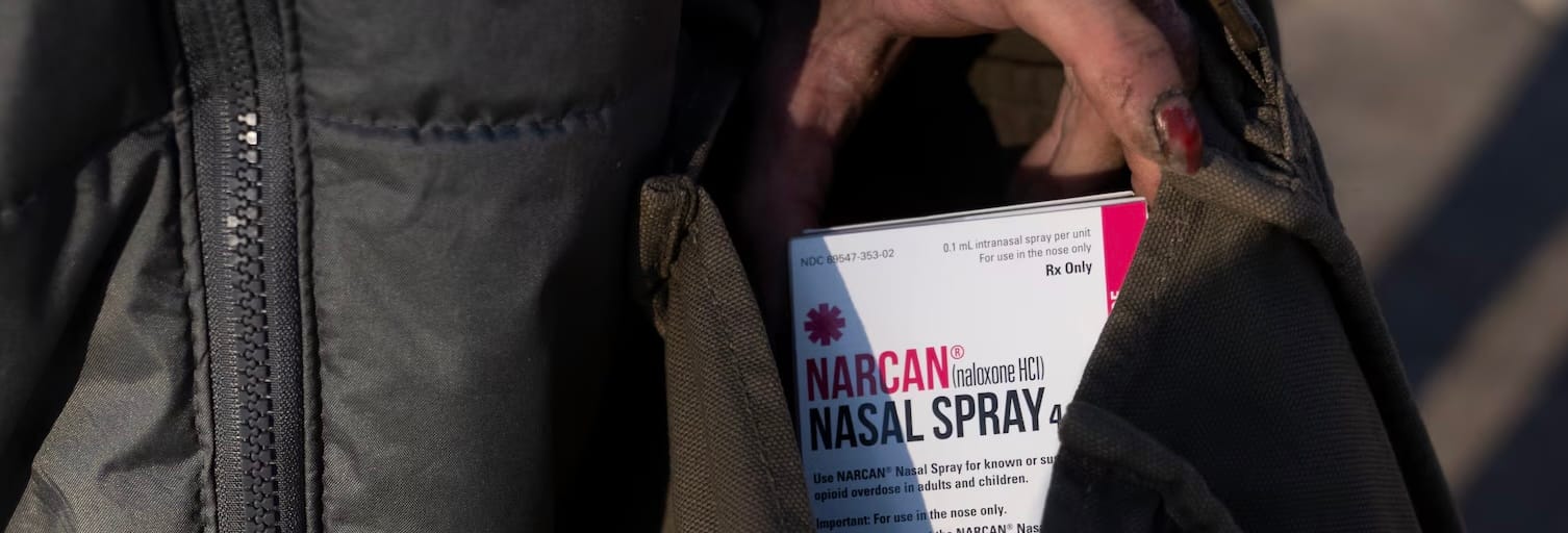 image of a box containing Narcan in someone's jacket pocket