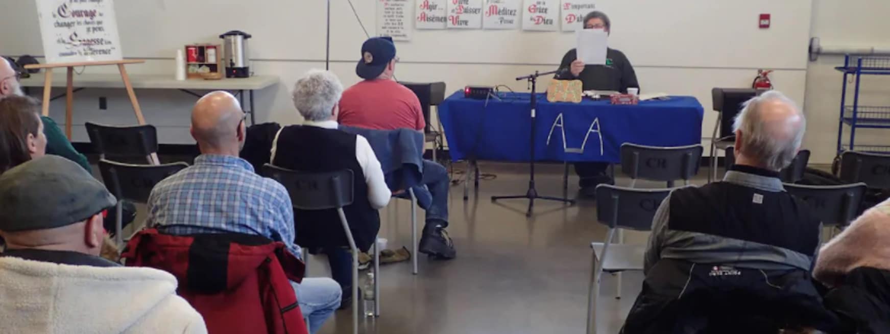 Adults sitting at an AA meeting
