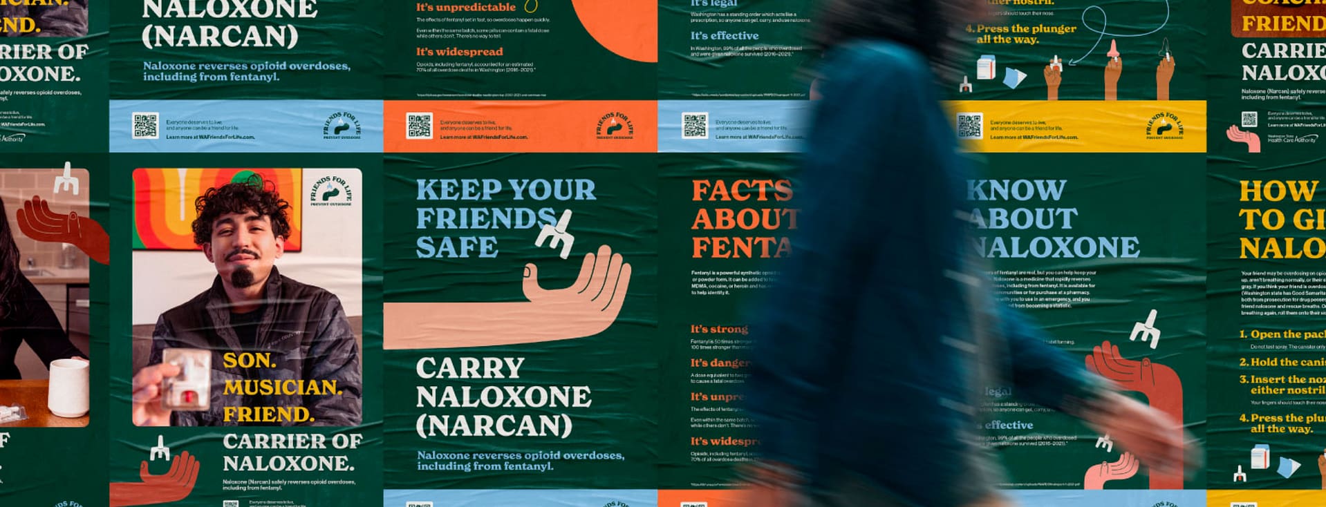 Person walking past posters for Narcan use