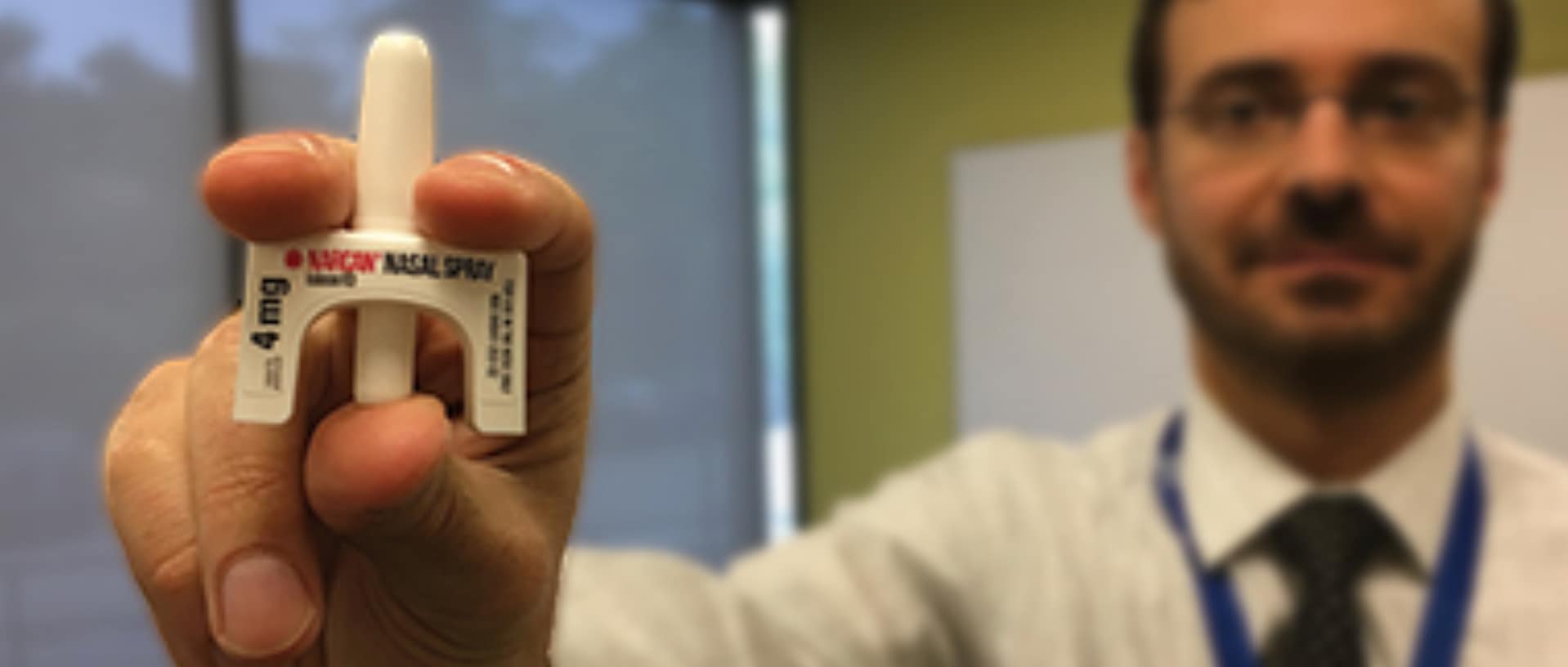 medical professional holding naloxone