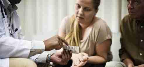 Doctor discussing prescribed medications with patients