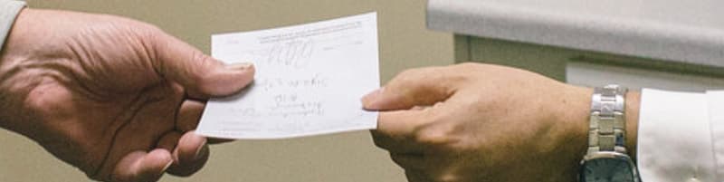 doctor handing patient a prescription