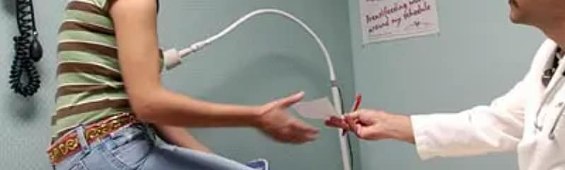 doctor handing prescription to patient