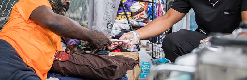 injection drug user receiving a clean syringe