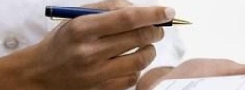 hand of medical prescriber holding pen