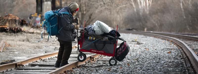 Homeless person in Bangor, Maine moving away from an encampment that was dismantled