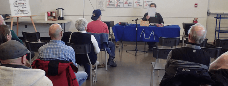 Adults sitting at an AA meeting