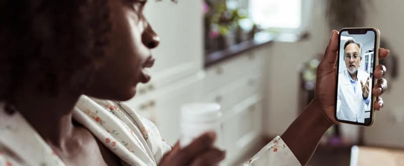 woman using her mobile phone for telemedicine