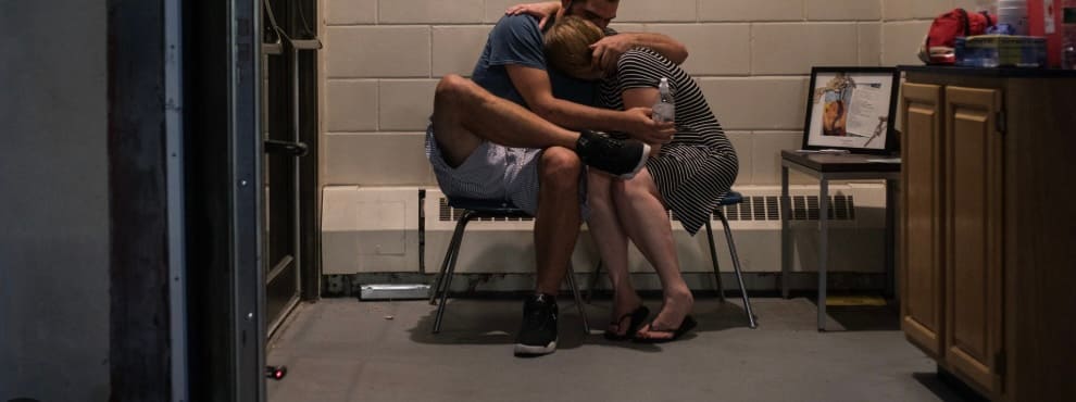 A man and woman holding and comforting each other