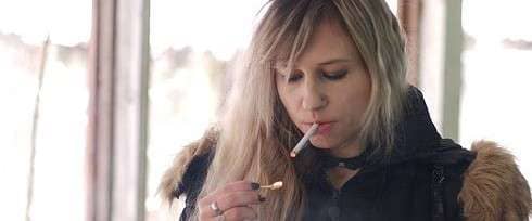 teenaged girl smoking cigarette