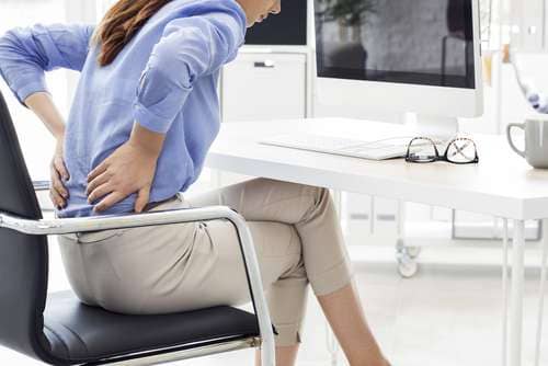 woman in chair with back pain