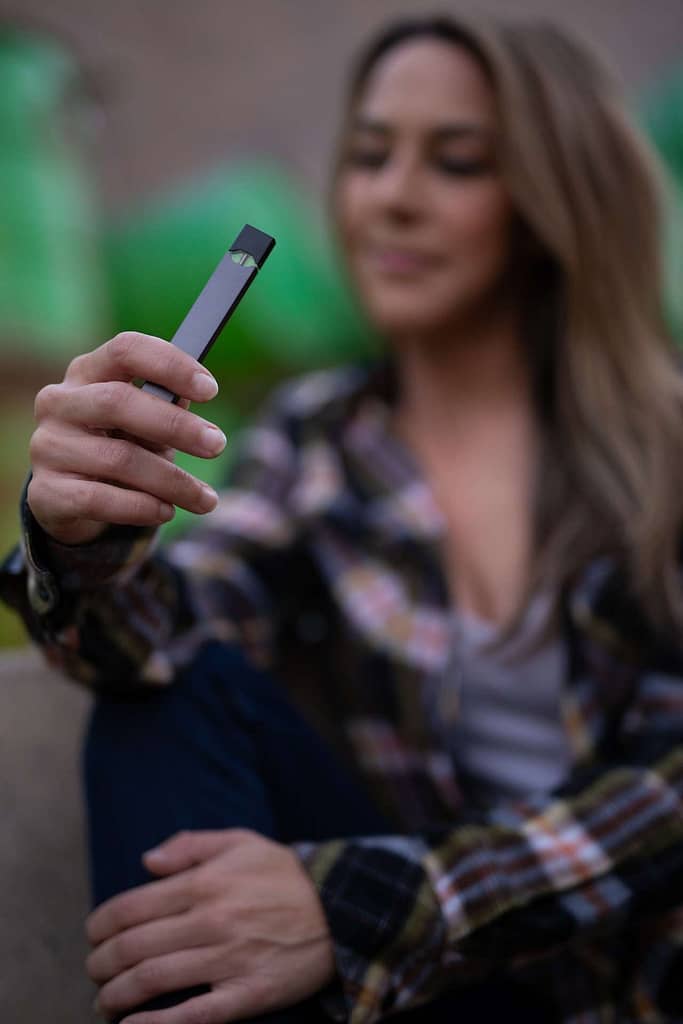 woman with a juul vaping device