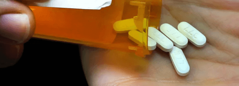 hand holding opioid pills