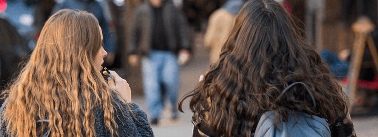 Girls walking and vaping