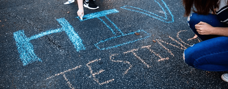 "HIV Testing" written on a street with chalk