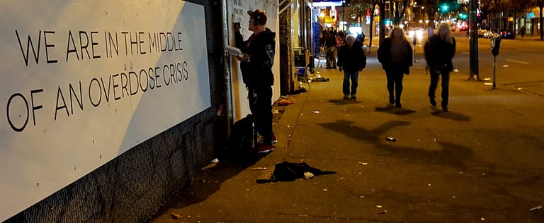 street scene in Ontario Canada with opioid crisis message
