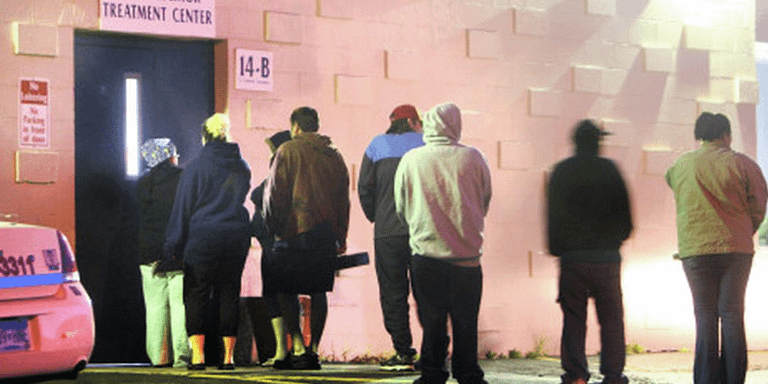 Line of people waiting outside a methadone clinic