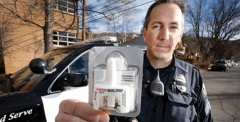 Police officer holding Narcan