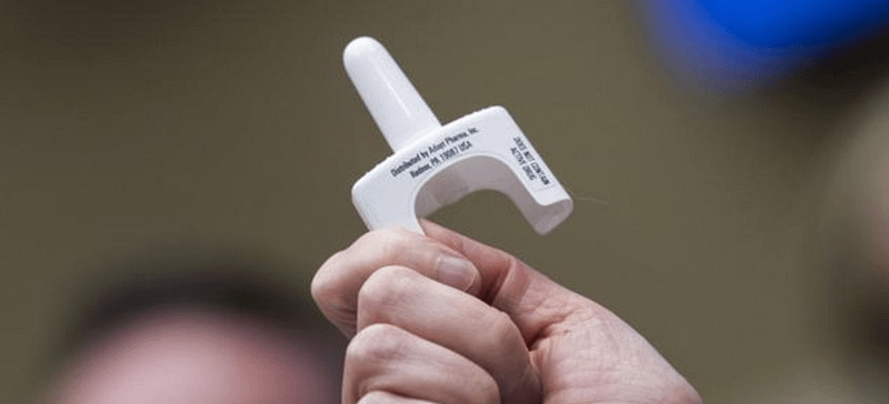 hand holding Naloxone inhaler