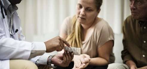 Doctor discussing prescribed medications with patients